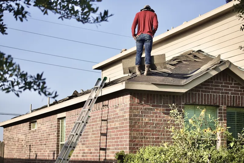 Professional roofer working on a residential roof in Fairway Fields